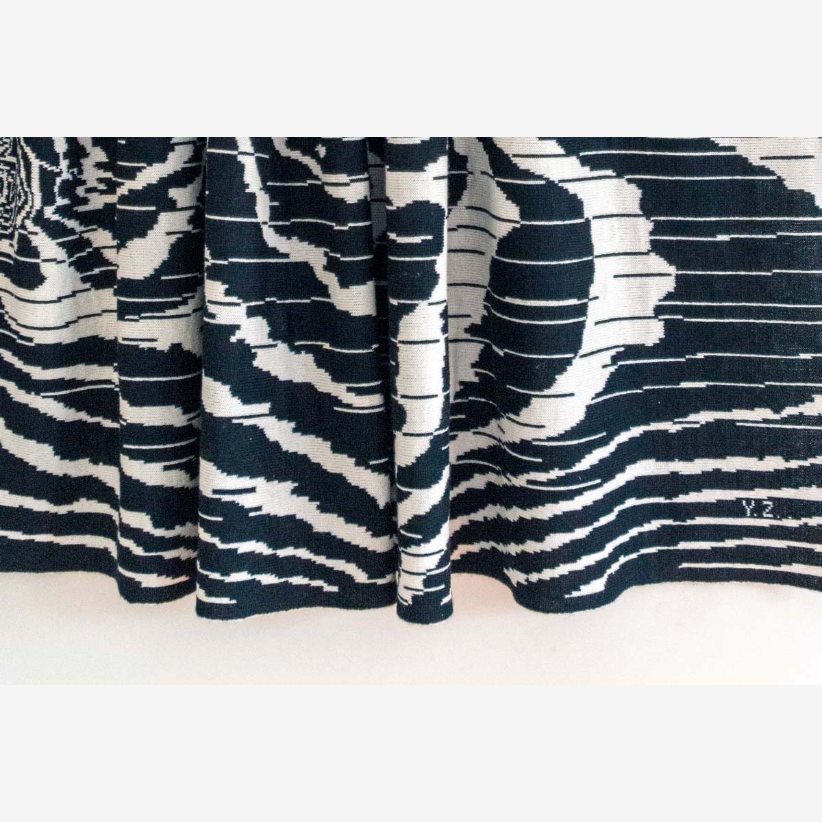 The patterned knit wool folds in closup view