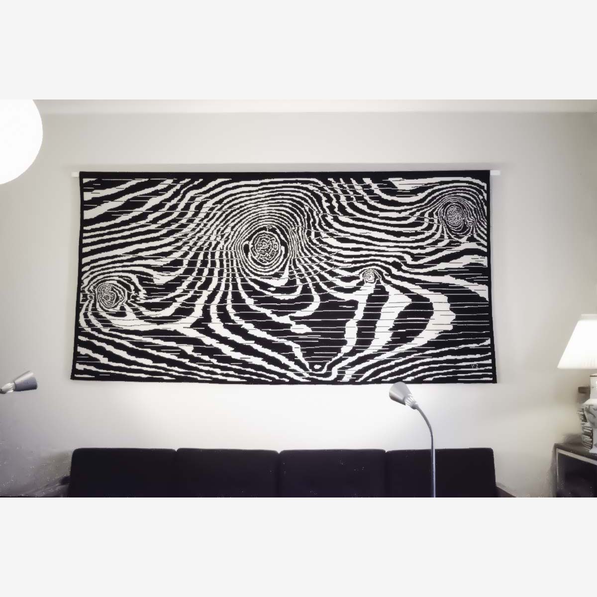 The unfolded wool drapery on the track, flat on the wall, almost filling the view frame, some furniture on the edges